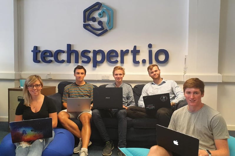 Interns with techspert sign